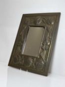 An Arts and Crafts embossed brass wall mirror, circa 1900,