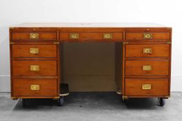 A large mahogany campaign-style desk and matching chair, of recent manufacture, in the 19th century