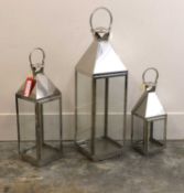 A group of three stainless steel lanterns, of recent manufacture,