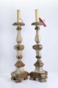 A pair of Continental gilt carved wood alter candlesticks, 18th to 19th century, later adapted