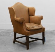 A George III-style mahogany and leather wing armchair, early 20th century,