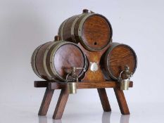 A novelty oak and brass mounted triple whisky barrel drinks dispenser, 20th century,