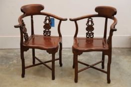 A pair of Chinese hardwood horseshoe back corner chairs, 20th century,