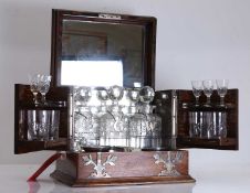 A late Victorian oak travelling tantalus with cut glass decanters and glasses, late 19th century,