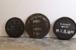 A group of three whisky barrel tops, 20th century,