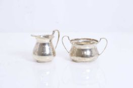 A silver three piece tea set,