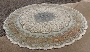 An Iranian Tabriz wool and silk blend circular rug, circa 1970s,