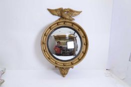 A gilt convex mirror, of modern manufacture,