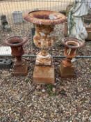 A large cast iron urn, and a pair of smaller garden urns, 20th century,