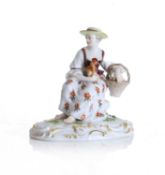 A Meissen figure of a seated lady with a hen and basket of eggs, late 19th century,