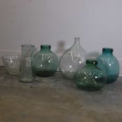 A collection of demijohns and glass vessels, 20th century, Spanish,