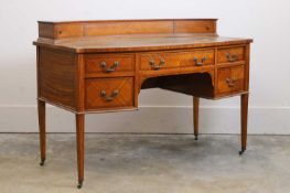 An Edwardian satinwood bow front desk, c.1920,