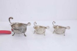 A collection of three silver sauce boats,
