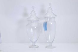 Two clear apothecary glass vases and covers, 20th century,