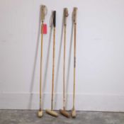 A comprized set of four Polo sticks, 20th century,