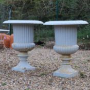 A pair of large French cast iron garden urns,