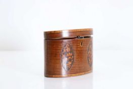 An oval harewood tea caddy,