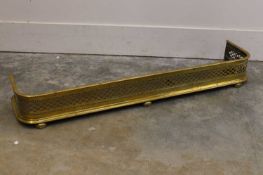 A pierced brass fender, 19th century,