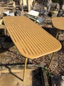 An outdoor dining table, of recent manufacture,