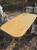 An outdoor dining table, Of recent manufacture,