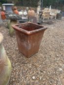 A large terracotta square garden planter,