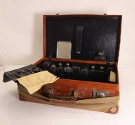 A leather vanity case with silver mounted items,