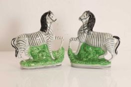 A pair of Staffordshire pottery zebra figures, 20th century,