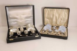 Two cased silver mounted porcelain coffee services,