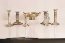 A group of silver candlesticks,