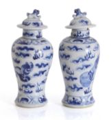 A pair of Chinese blue and white vases and covers, late 19th century,