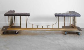 A brass framed and upholstered club fender, of recent manufacture,