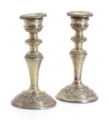 A pair of silver candlesticks,