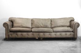 A large grey leather upholstered chesterfield sofa, of recent manufacture,