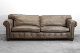 A large grey leather upholstered chesterfield sofa, of recent manufacture,