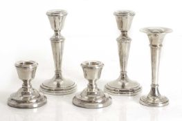 A collection of silver candlesticks,