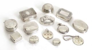 A collection of silver pill boxes,
