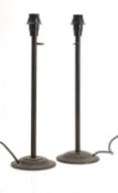 A pair of patinated brass table lamps,