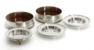 A collection of silver pin dishes and coasters,