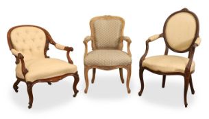 A collection of three armchairs,