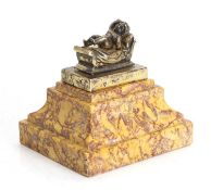 A marble and silver desk weight,