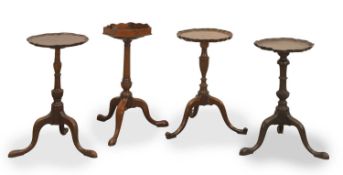 A collection of four mahogany tripod wine tables, 19th century,