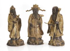 Three Chinese gilt-brass figures of of 'Lu', 'Fu' and 'Shou', early 20th century,