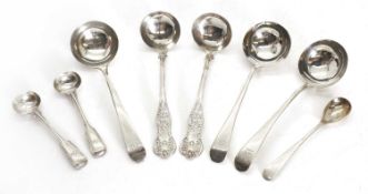 A collection of silver spoons and ladles,