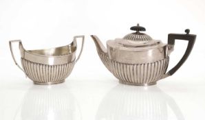 A silver teapot and matching sugar bowl,