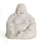 A Chinese blanc de chine porcelain figure of a Budai,