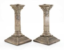 A pair of Edwardian Corinthian column candlesticks,