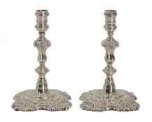 A pair of small silver candlesticks,