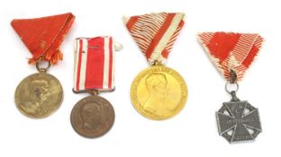 An Austrian gold grade Bravery Medal and a Merit Cross WWI era,