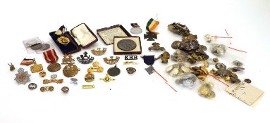 A collection of cap badges and shoulder badges 20th century,