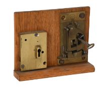 An Aubin A1 Guardian Safe Lock, mounted on an oak display board